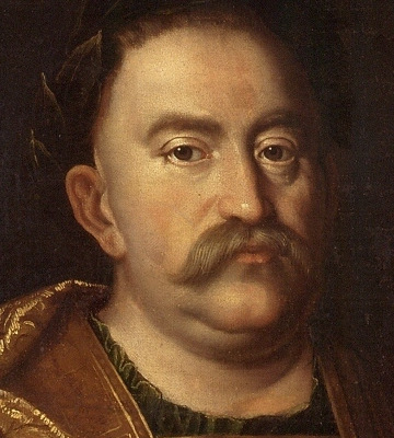 Zbliżenie na fragment obrazu olejnego "Jan III Sobieski w wieńcu laurowym". Twarz króla w zbliżeniu. brązowe, spokojne oczy, długi nos, wąsy. 