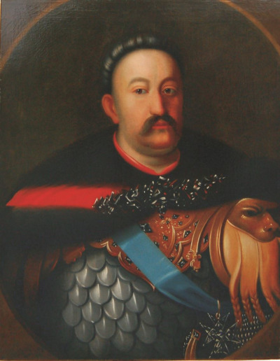 Portret Jana III Sobieskiego w zbroi. Jest to olej na płótnie. Król ubrany jest w zbroję i delię. Na piersi błękitna wstęga z krzyżem. Król patrzy dumnie na wprost.