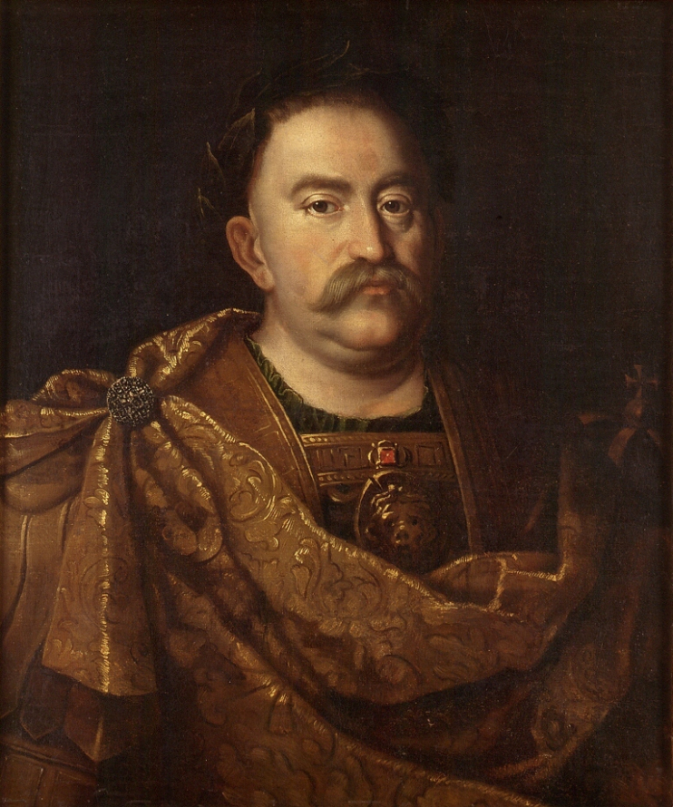 Obraz "Jan III Sobieski w wieńcu laurowym". Król ubrany w pancerz inspirowany strojem znanym z posągów cesarzy oraz złocisty, brokatowy paludament - płaszcz żołnierski. Gorgona - maska, zdobi pancerz na wysokości piersi króla. Na głowie króla spoczywa wieniec laurowy. W tle portretu dyskretnie zaznaczona, spoczywająca po prawej stronie króla korona. 